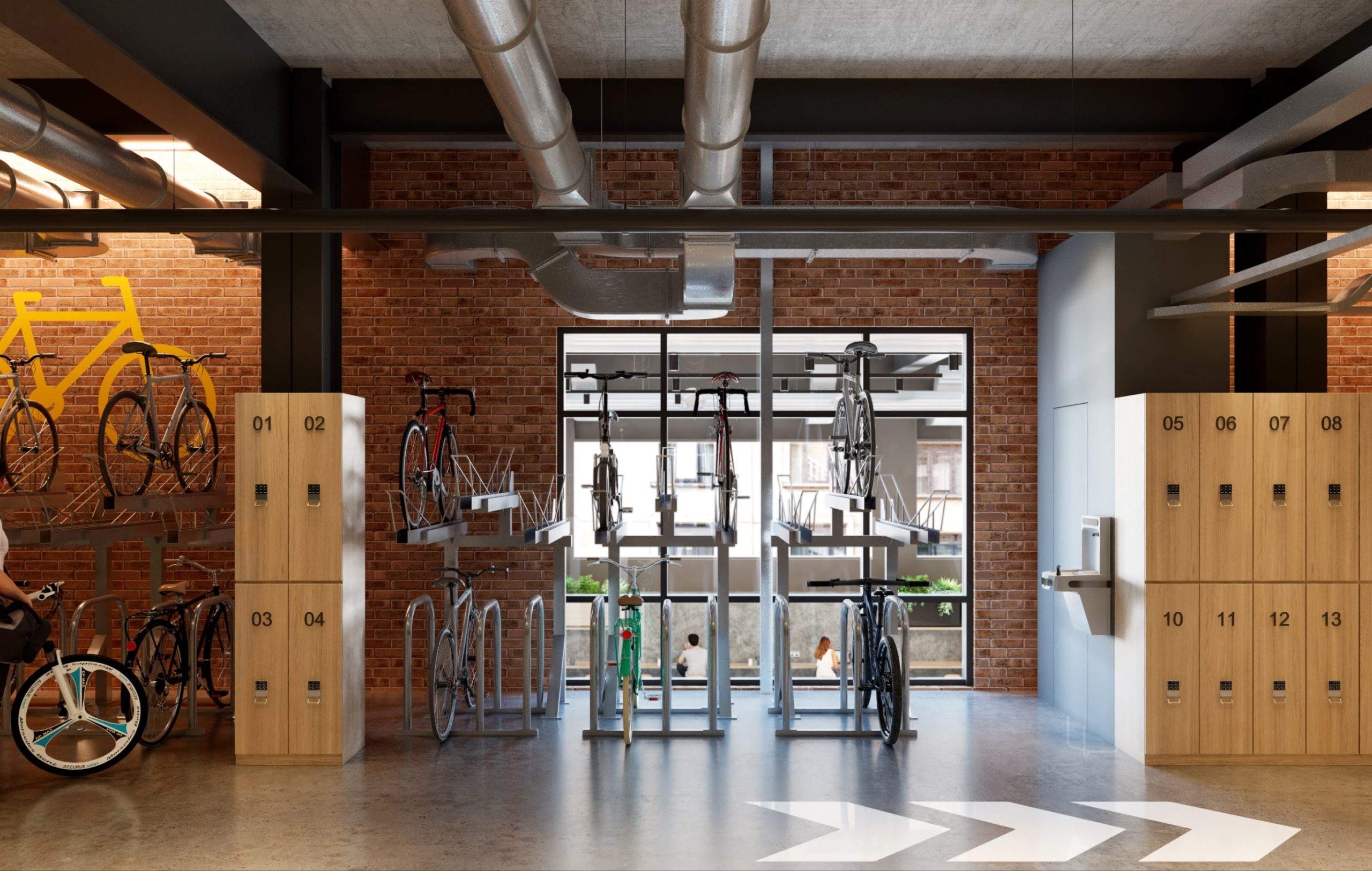 A bike rack inside with drinks station and wooden lockers nearby,